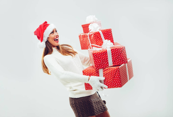 Cheerful woman holding presents  - Zdjęcie, obraz