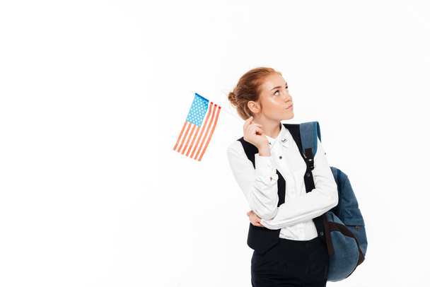 Serious pensive gigner student woman with backpack holding USA flag - Photo, Image