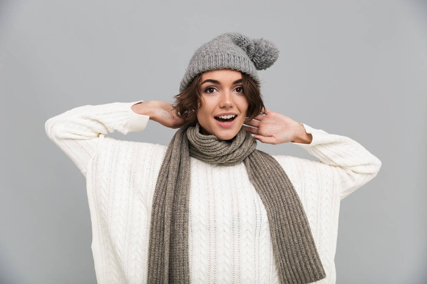 Portrait of a cheerful excited girl in scarf and hat - Foto, imagen
