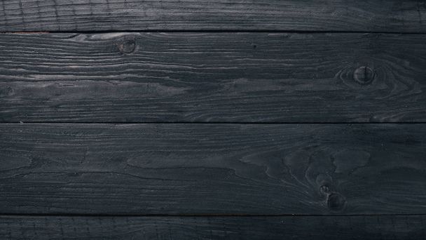 Wooden black texture background. Top view. Free space for your text. - 写真・画像