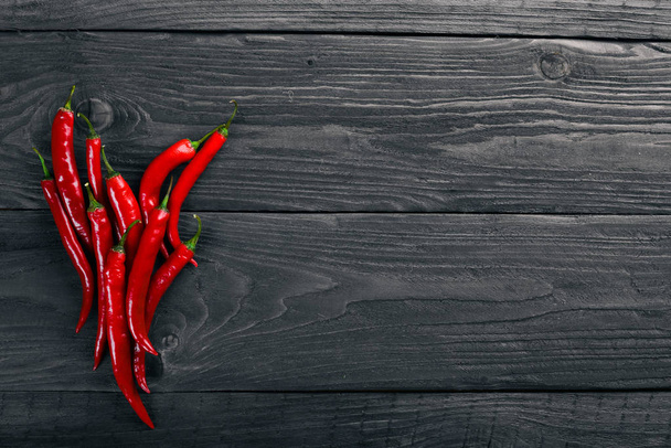 Chili red pepper. On a wooden background. Top view. Free space for your text. - Fotografie, Obrázek