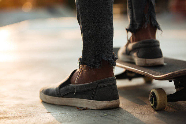 Close up of skateboarders feet skating - Фото, зображення