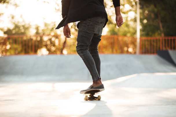 Cropped image of a young teenage skateboarder in action - Φωτογραφία, εικόνα