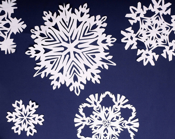 Winter style background.Paper snow flakes on purpe background - 写真・画像