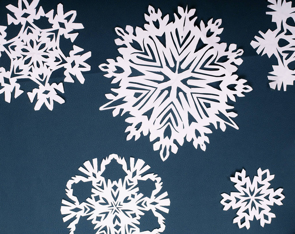 Winter style background.Paper snow flakes on blue background - 写真・画像