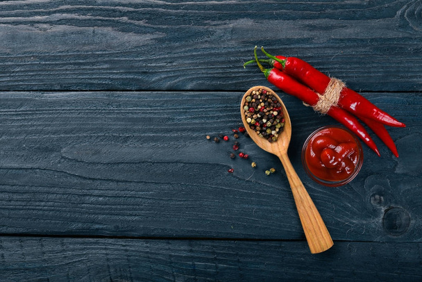 Hot spices Chili and Spice Red Peppers. On a wooden background. Top view. Free space for your text. - Фото, изображение