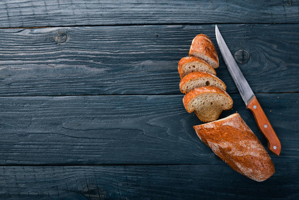 Assortment of bread and baking. On a wooden background. Top view. Free space for your text. - Photo, Image