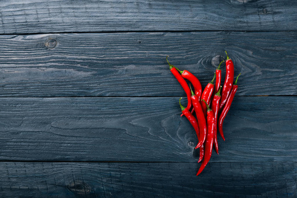 Chili red pepper. On a wooden background. Top view. Free space for your text. - Fotoğraf, Görsel