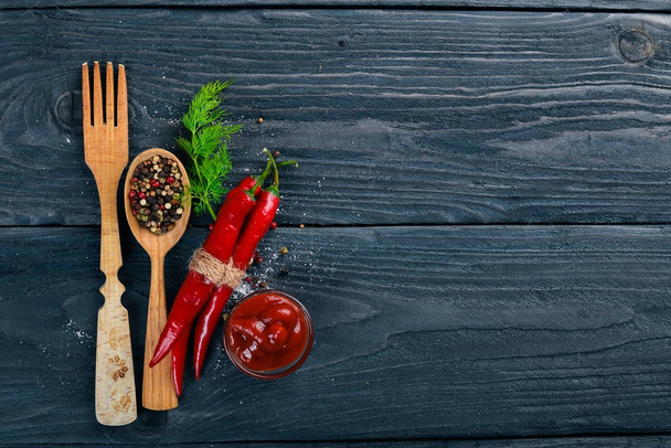 Hot spices Chili and Spice Red Peppers. On a wooden background. Top view. Free space for your text. - Zdjęcie, obraz