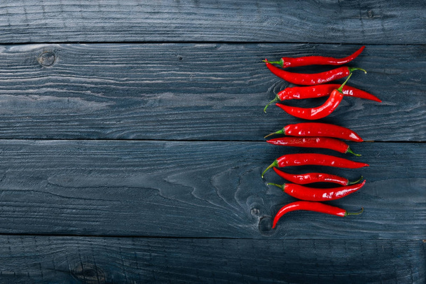 Chili red pepper. On a wooden background. Top view. Free space for your text. - Fotografie, Obrázek