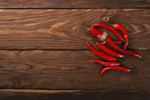 Chili red pepper. On a wooden background. Top view. Free space for your text. - Fotó, kép