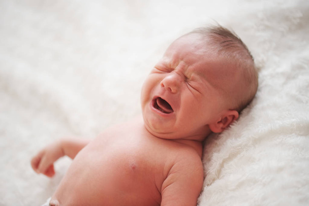 cute crying newborn baby at home - Foto, imagen