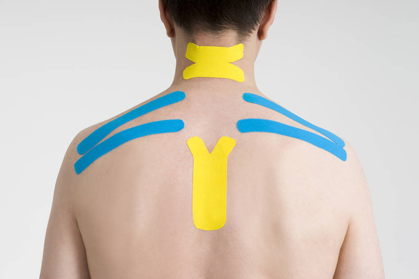 Kinesio tape, kinesiology taping on human back - Foto, Imagen