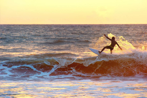 Surfer at sunset, silhouette - Fotó, kép