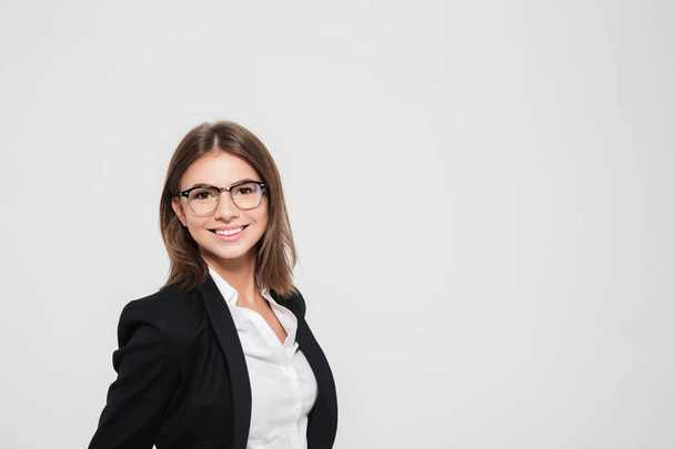 Portrait of a smiling pretty female manager in eyeglasses - Photo, image