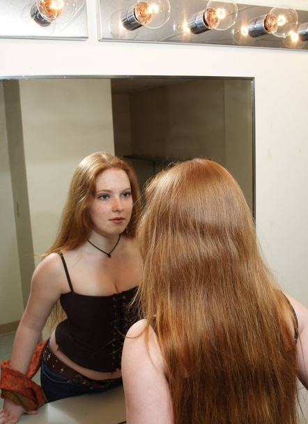 young woman looks at reflection - Photo, Image