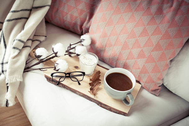 Autumn cozy breakfast. Romantic breakfast. Cotton, a cup of hot coffee, a candle, a plaid, glasses. Autumn cosiness. A tray with - Photo, Image