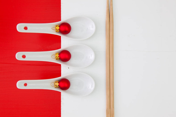 Ceramic spoons and bamboo chopsticks for sushi food  - Fotó, kép
