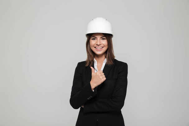 Portrait of a satisfied confident woman in hard hat - Фото, изображение