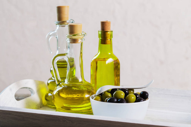 Olive oil  on the wooden table - Фото, изображение