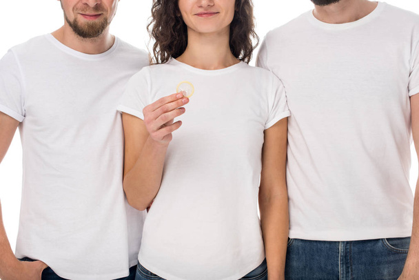 mujer sosteniendo condón con los hombres en los lados
 - Foto, Imagen