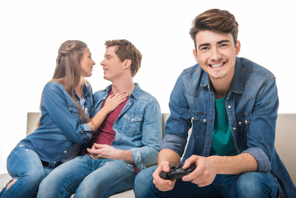 man with joystick and young couple - Фото, зображення
