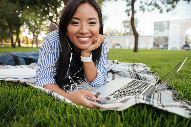 Close-up photo of young smiling asian female student listening t - Foto, Imagen