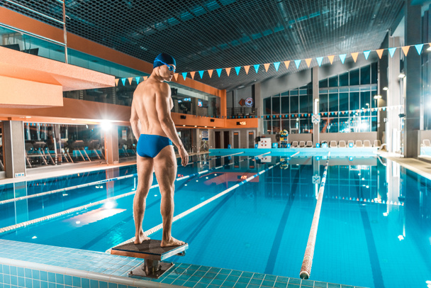 muscular swimmer at competition pool - Fotoğraf, Görsel