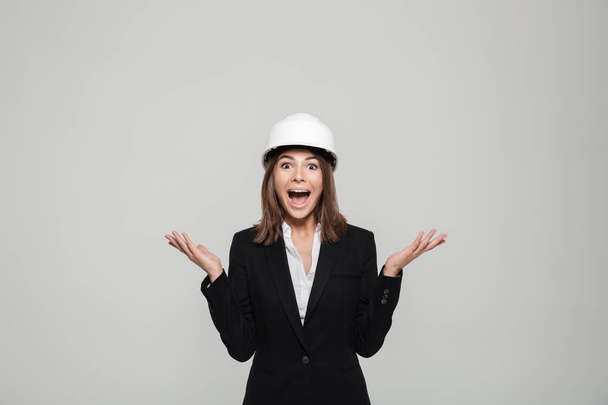 Portrait of an excited cheerful woman in hard hat - Φωτογραφία, εικόνα