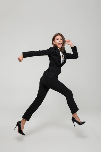 Full length portrait of crazy busy businesswoman in suit - Zdjęcie, obraz