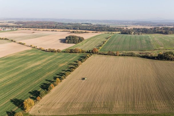 aerial view of the tractor on the harvest field - Valokuva, kuva
