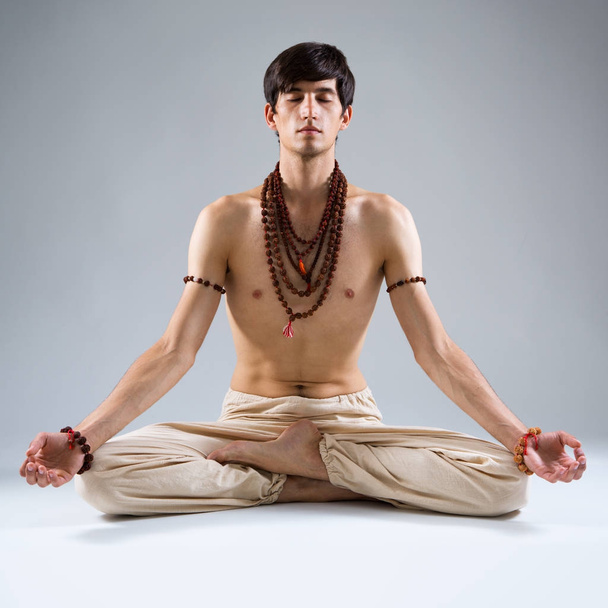 Young man doing yoga  - Фото, изображение