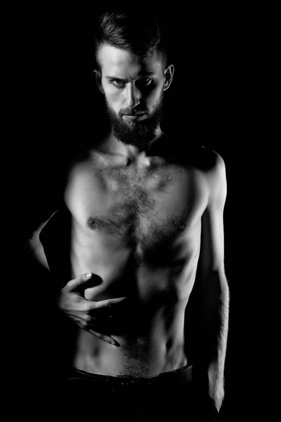 slim bearded man with thin bare torso isolated on black - Фото, зображення