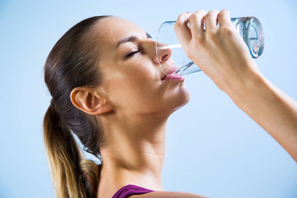 Young woman drinking water - Photo, Image