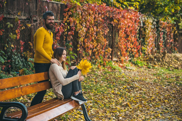 Man and woman with yellow tree leaves. - Photo, image