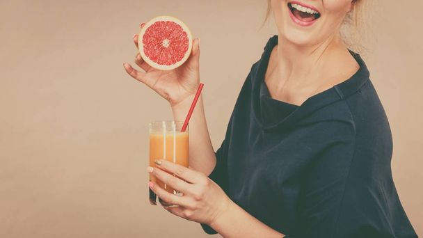 Happy woman holding fresh orange juice - Photo, image