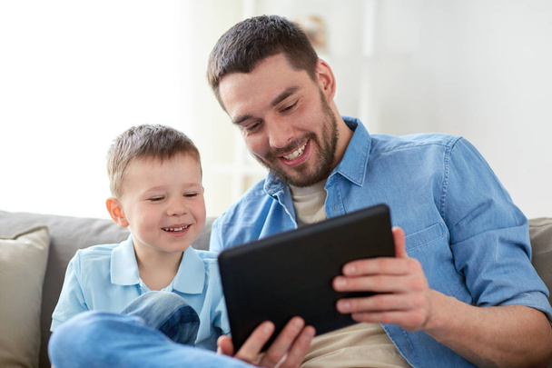father and son with tablet pc playing at home - Φωτογραφία, εικόνα