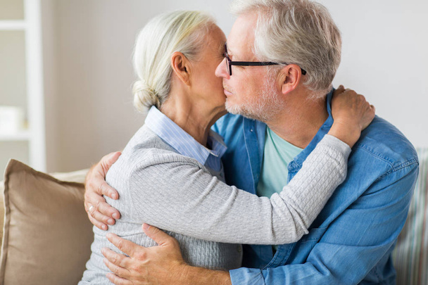 close up of happy senior couple hugging at home - 写真・画像