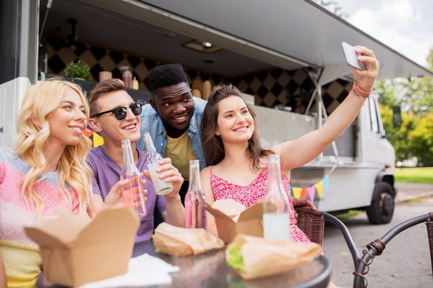 happy young friends taking selfie at food truck - Φωτογραφία, εικόνα