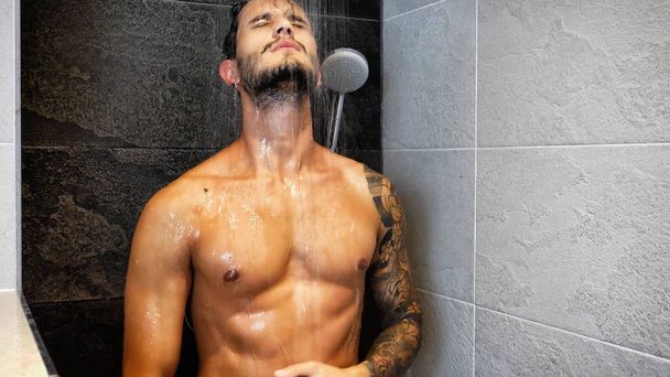 Attractive Young Muscular Man Taking Shower - 写真・画像