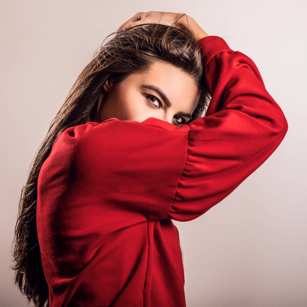 Young sensual model woman in red pose in studio. - Fotografie, Obrázek