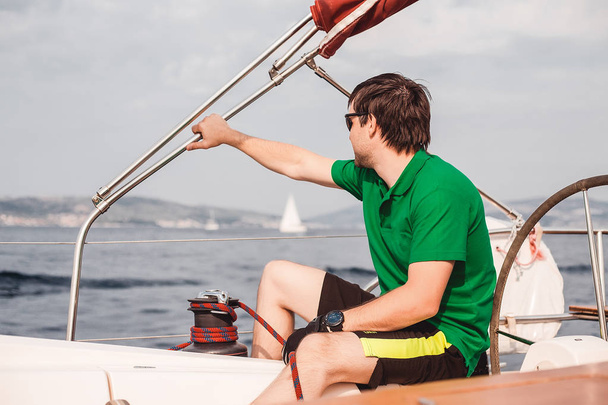 young  man  on the yacht - Фото, изображение