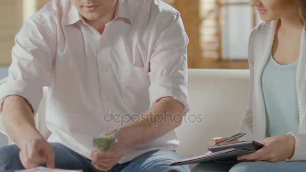 Male counting money, putting it aside, hugging female, bank mortgage, happiness - Кадри, відео