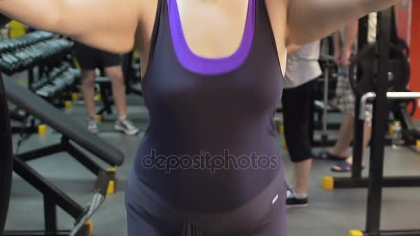Plump girl working out in the gym and jumping rope, weight loss, fitness - Materiaali, video