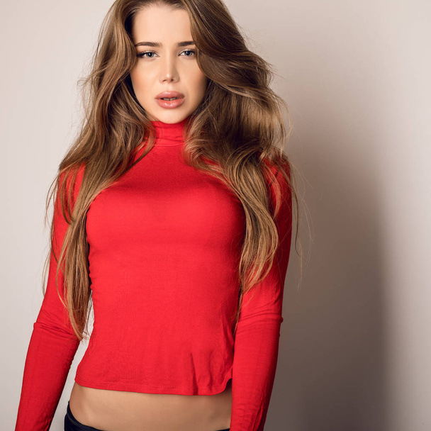 Young sensual model woman in red pose in studio. - Фото, зображення