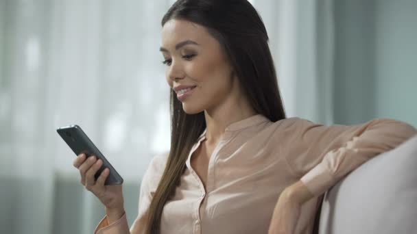 Beautiful woman enjoying phone application, studying modern program interface - Πλάνα, βίντεο