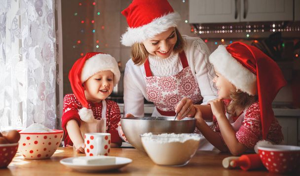 família feliz mãe e crianças assar biscoitos para o Natal
 - Foto, Imagem