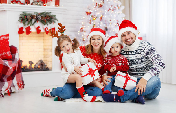 gelukkig gezin vader moeder en kinderen op kerstochtend - Foto, afbeelding