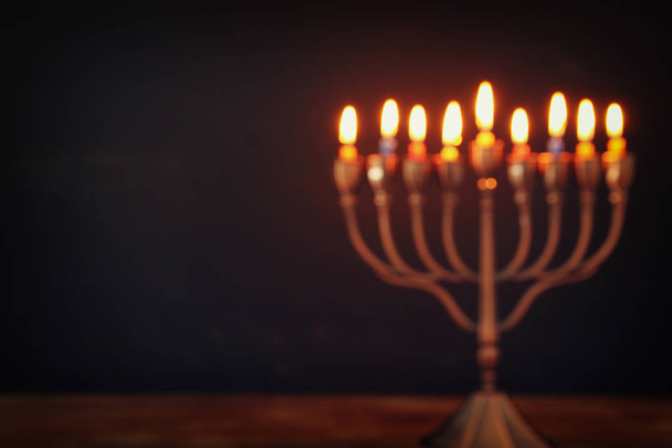 Abstract blurred image of jewish holiday Hanukkah background with menorah (traditional candelabra) - Photo, Image