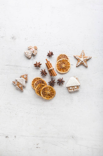 Cinnamon star anise gingerbread and dry orange on white concrete background. Top of view - Photo, Image